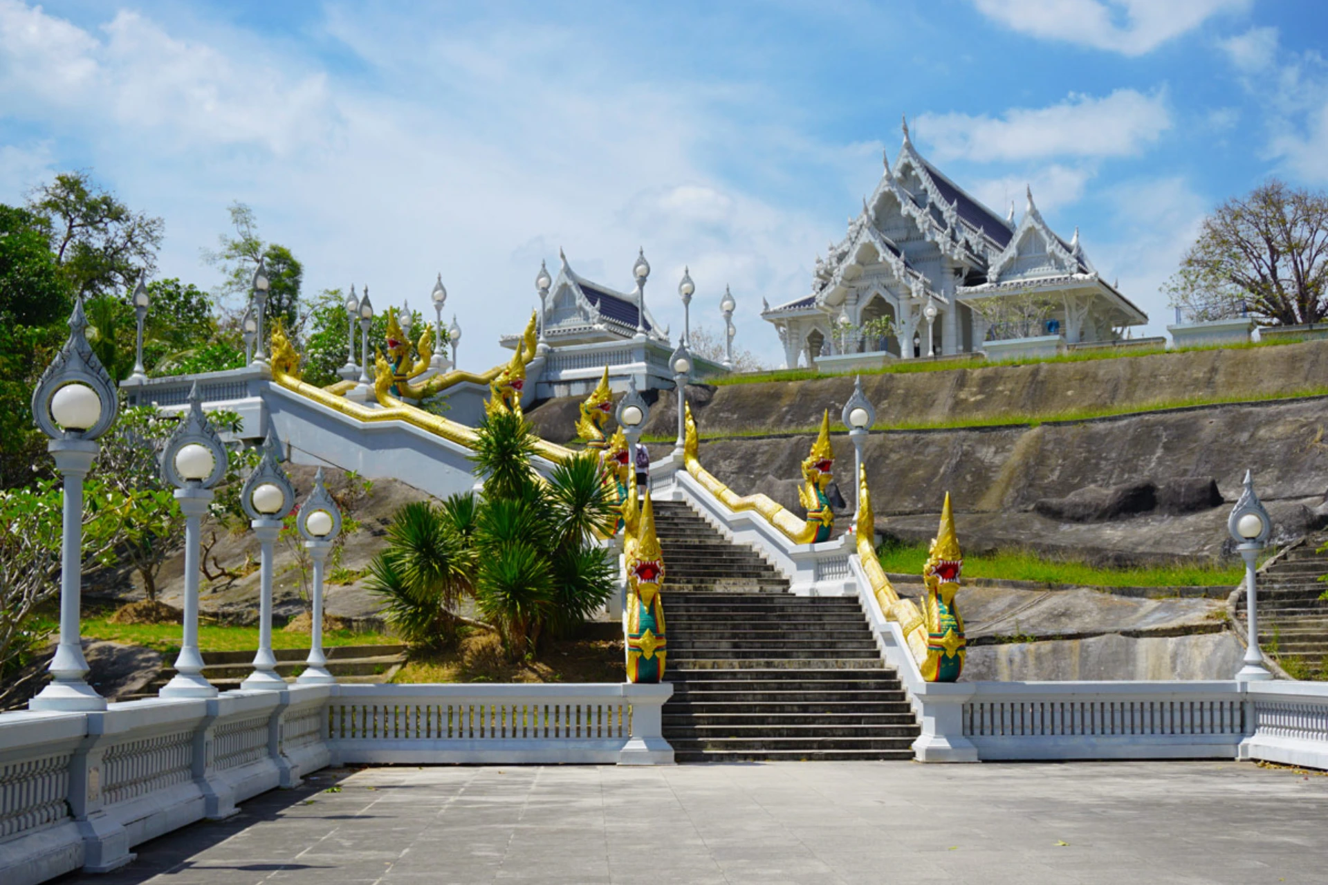 White staircase with gold dragons leading to Wat Kaew temple in Krabi