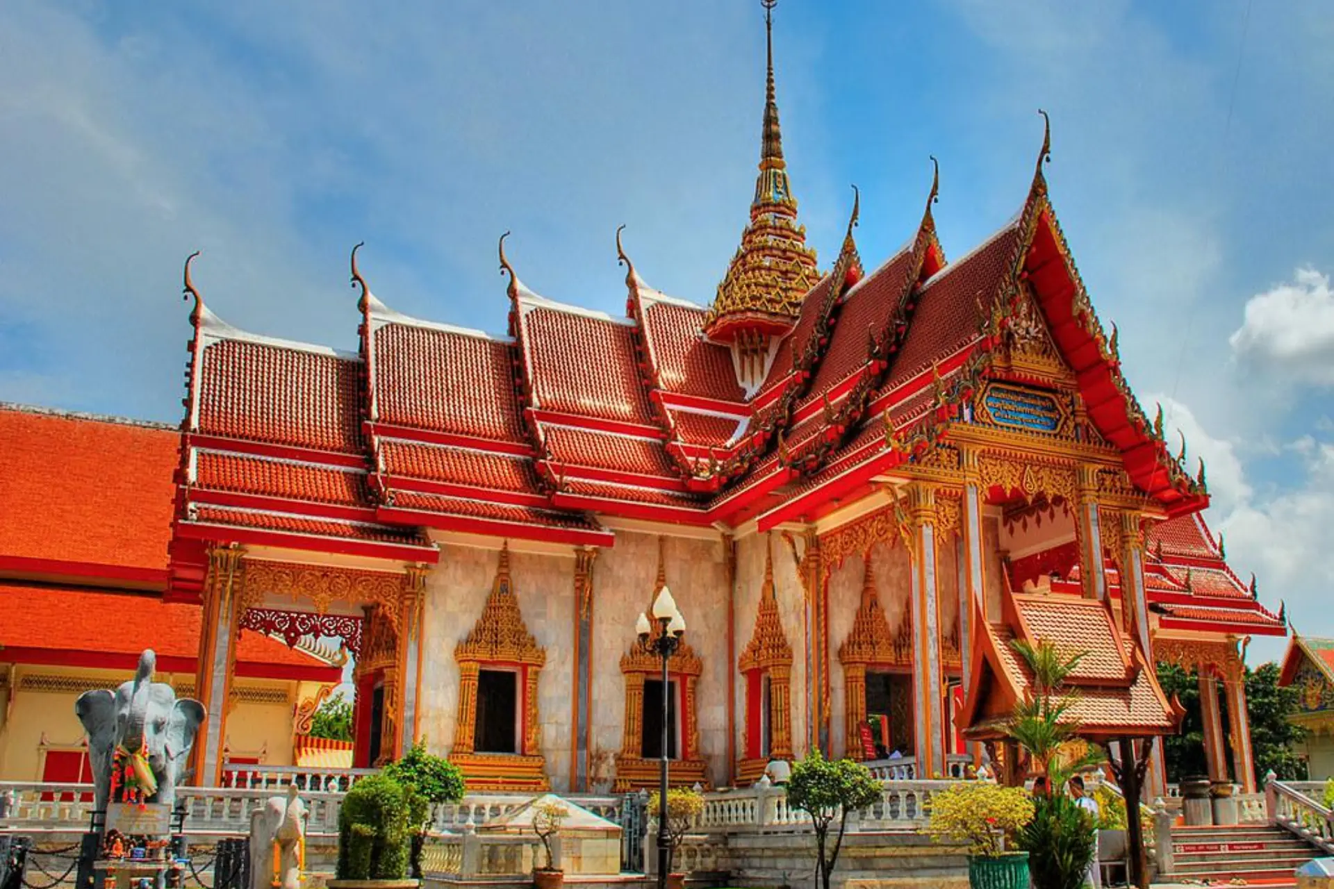 Chalong Temple with red roofs and gold decorations